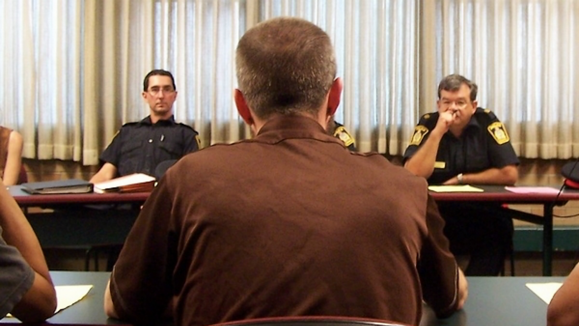 A photo from behind me showing me facing three Winnipeg police across the room